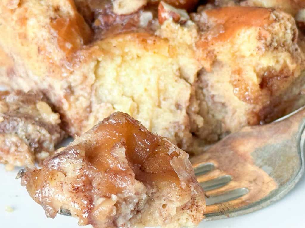 A bite of bread pudding on a fork.