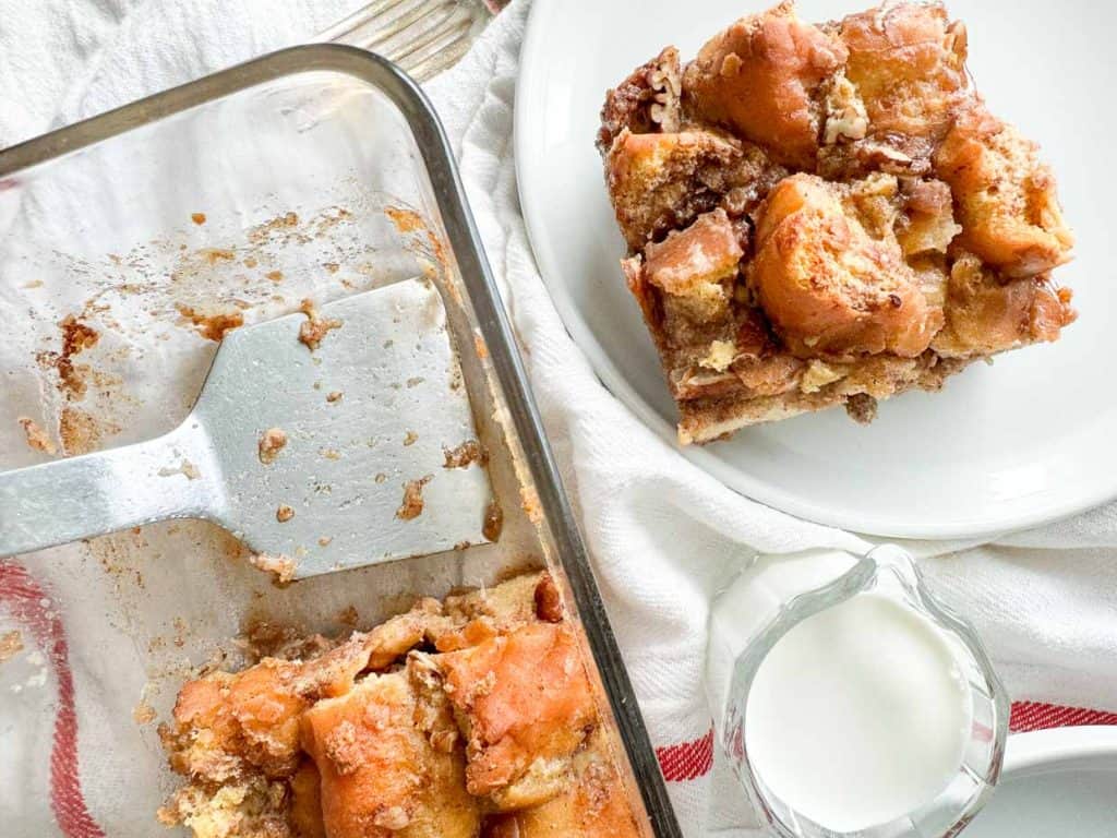 Donut bread pudding on a plate and in the baking dish. 