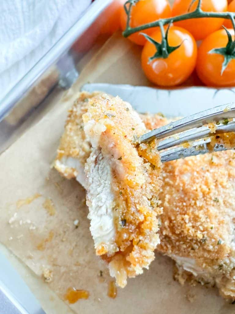 A crispy bite of chicken on a fork.