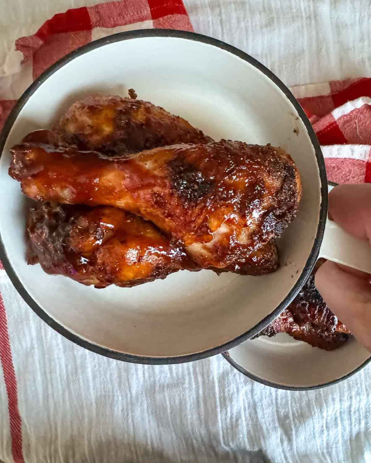 A chicken drumsticks in a pan.