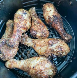Chicken that is halfway cooked in the air fryer.