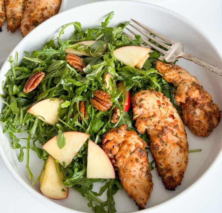 Ranch chicken in a blate with a salad.