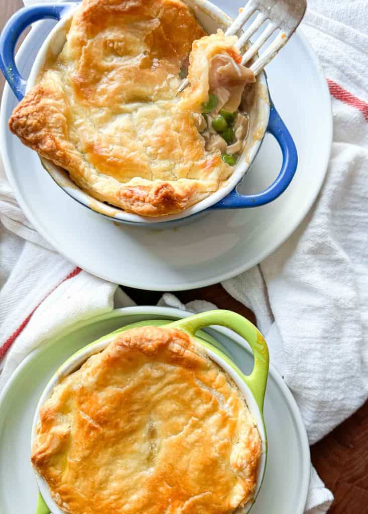 Individual Chicken pot pies on plates.