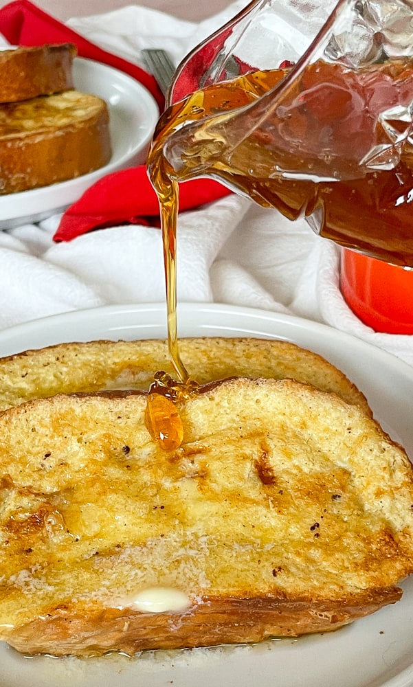 Syrup pouring over french toast. 