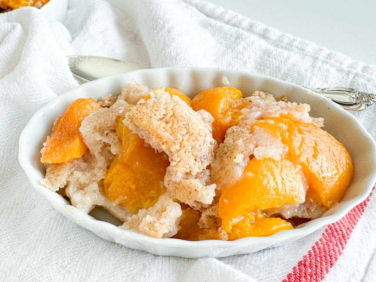 Small dish of spiced peach cobbler.