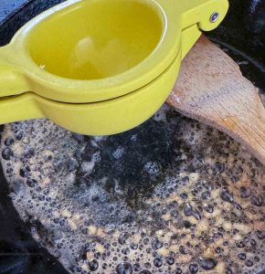 Squeezing lemon juice into a skillet.