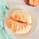 Peach hand pies on a plate.