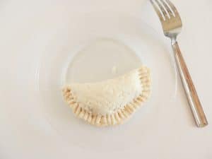 Fork prints on a folded over biscuit.