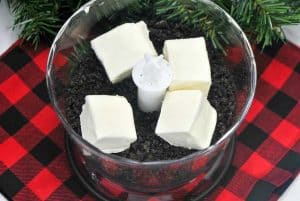Cream cheese added to crushed Oreos in a food processor.