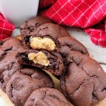 Stuffed buckeye cookies, one split to reveal the inside.