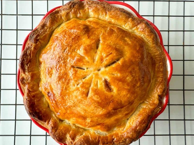 The baked pie cooling on a wire rack, showing its crisp, golden crust.