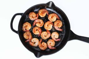 Shrimp for Chimichurri shrimp seared in a skillet.