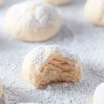 A cream cheese cookie with a bite taken, showing its soft interior.