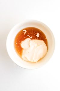 Bowl with mayonnaise and honey for the sauce.