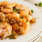 Close-up of honey walnut shrimp on a white plate.