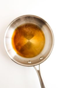 Sauce pan with honey glaze heating.