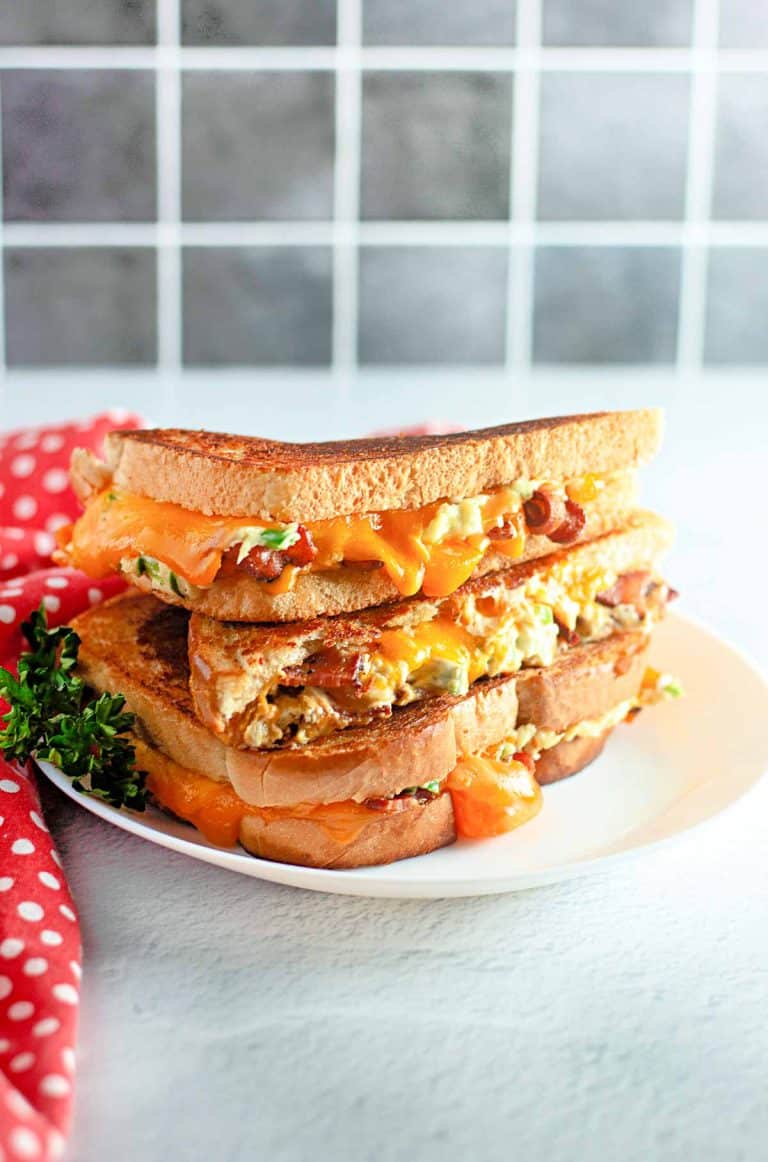 Stacked Jalapeño Popper Grilled Cheese on a white plate.