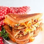 Stacked Jalapeño Popper Grilled Cheese on a white plate.