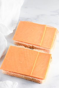 Cheddar cheese slices on sandwich bread.
