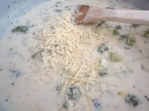 Grated parmesan sprinkled into broccoli soup.