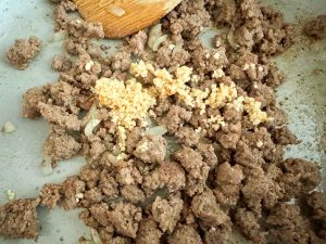 Cooked ground beef with minced garlic added.