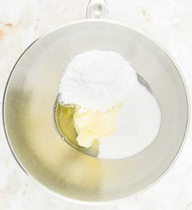 Butter, sugar, and powdered sugar in a mixing bowl.