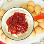 Cranberry sauce spooned over the cheesecake mixture surrounded by vanilla wafers.