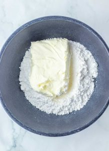 Cream cheese and powdered sugar in a mixing bowl for filling.