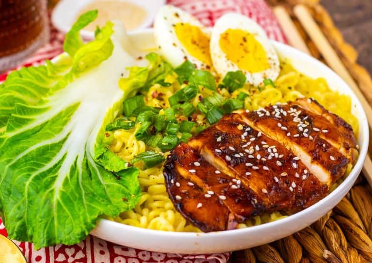Close-up of chicken ramen showing sliced chicken, noodles, and soft-boiled eggs.