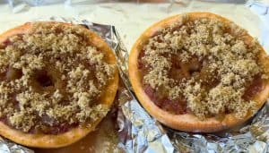 Two grapefruit halves with brown sugar on foil for Broiled Grapefruit.
