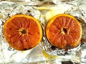 Broiled Grapefruit halves on foil after cooking.