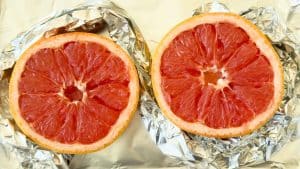 Grapefruit halves on foil for Broiled Grapefruit.