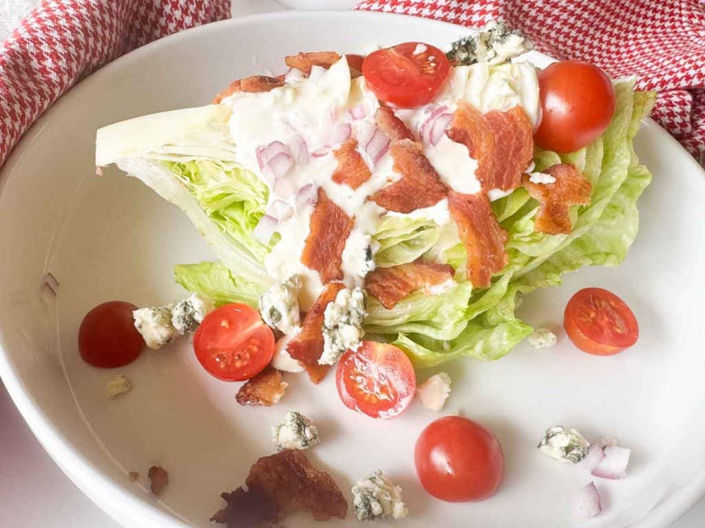 Wedge salad served on a white plate.